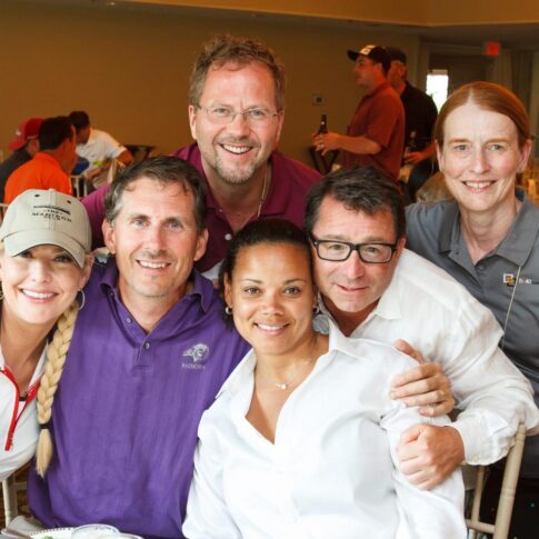 Golf tournament attendees pose for a group picture