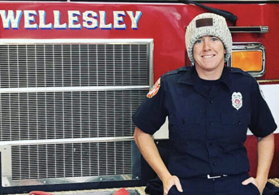 Joanie Cullinan standing in front of a Wellesley fire truck