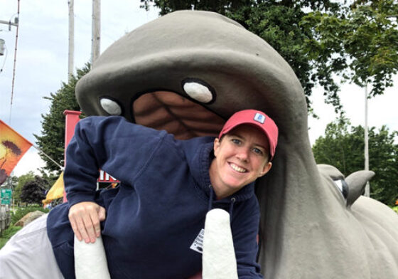 Joanie striking a funny pose in the mouth of a walrus statue