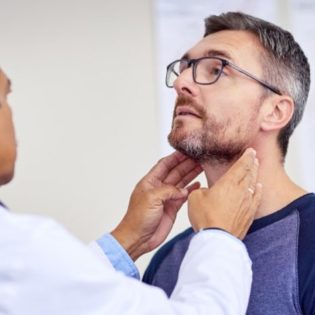 Men having his throat examined by doctor