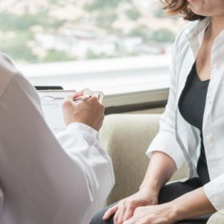 woman sitting with doctor