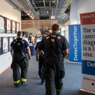 Firefighters stream into free skin screening hosted by DetecTogether held at Polar Park in Worcester, Mass.